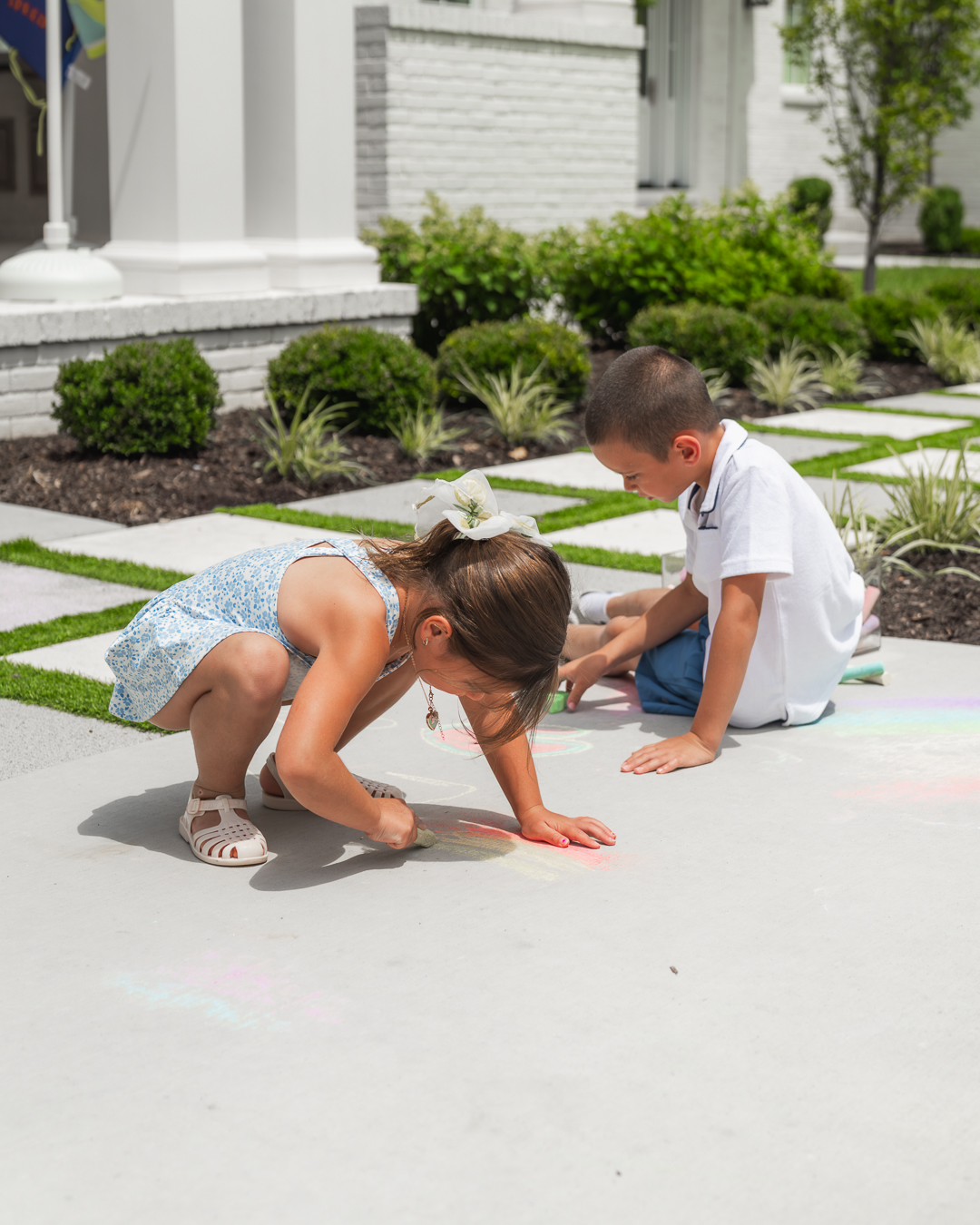 Sitter playing with kids in the front yard