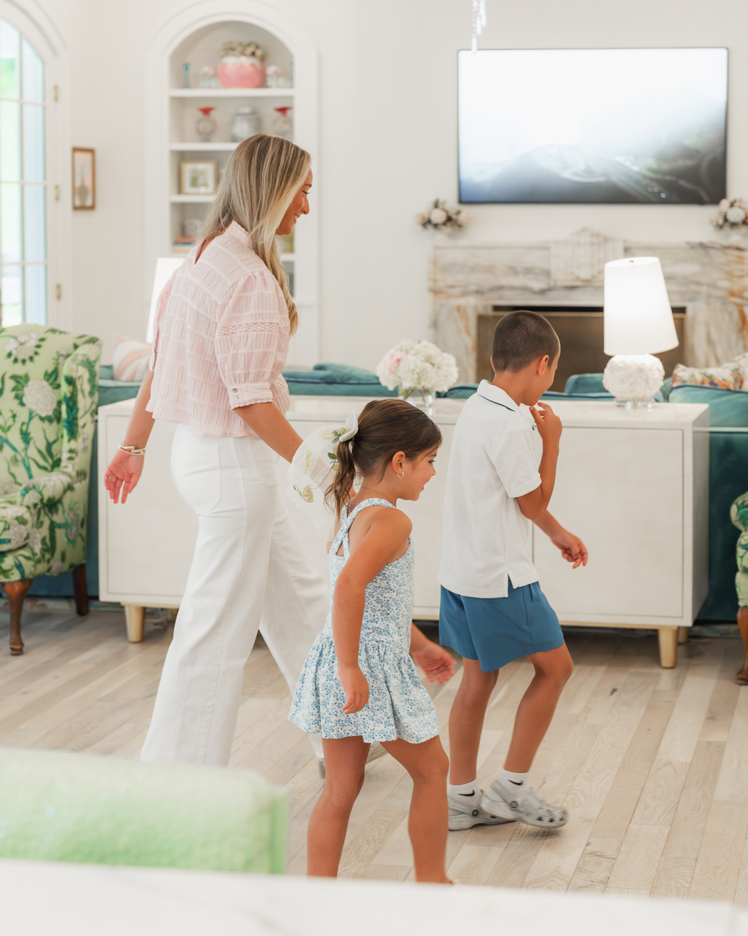 Sitter playing with kids in the living room