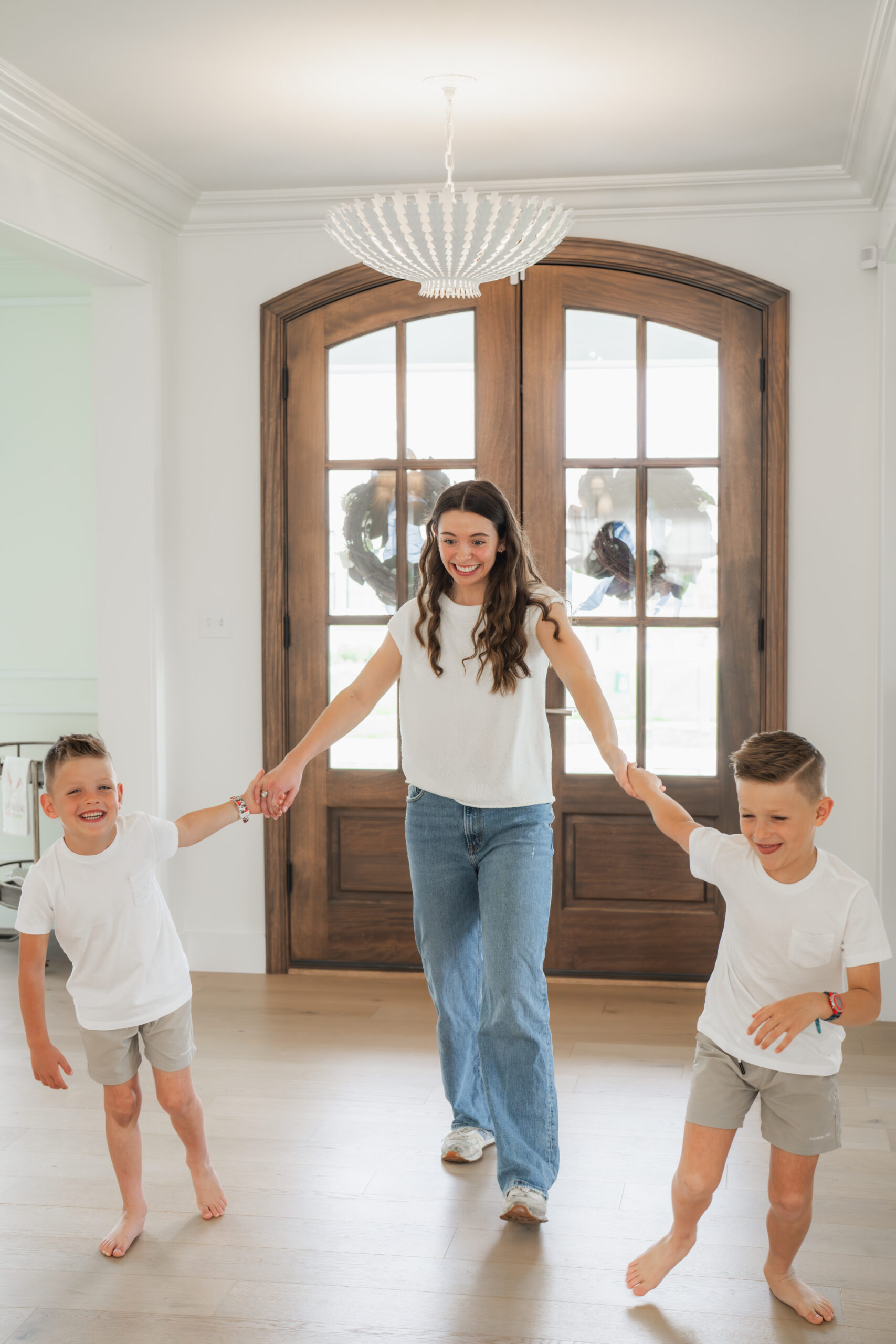 Find-A-Sitter nanny walking hand in hand with two young boys