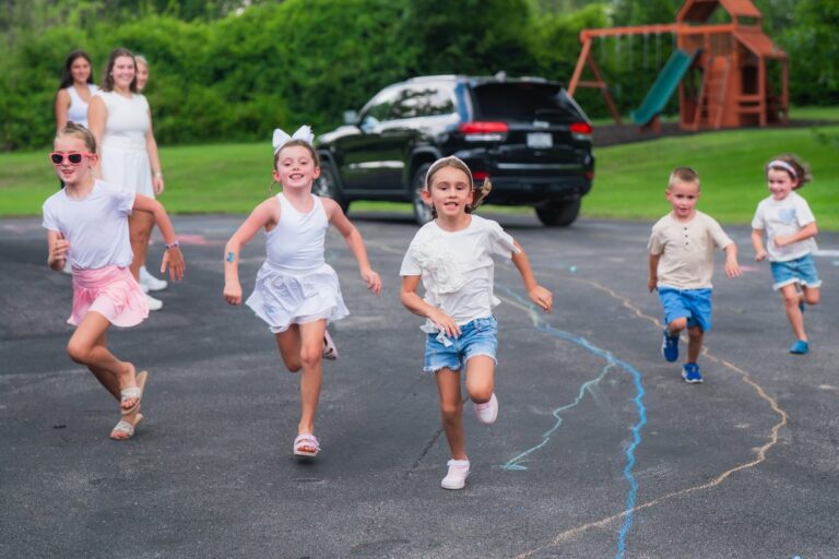 Kids racing across the driveway with their Find-A-Sitter sitters